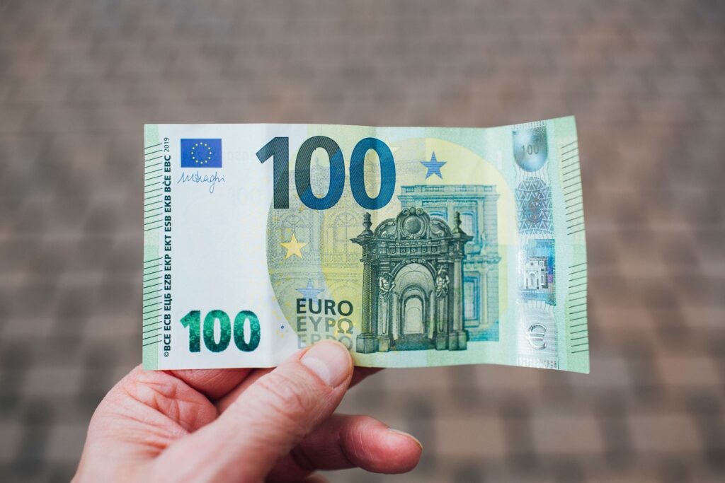 Traveler holding a 100 Euro banknote before exchanging foreign currency in Bali, Indonesia.