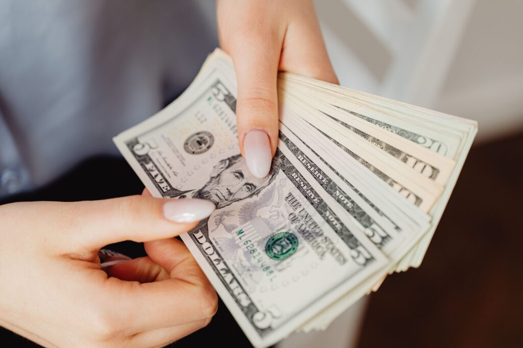 Checking banknotes closely to avoid currency exchange scams in Bali