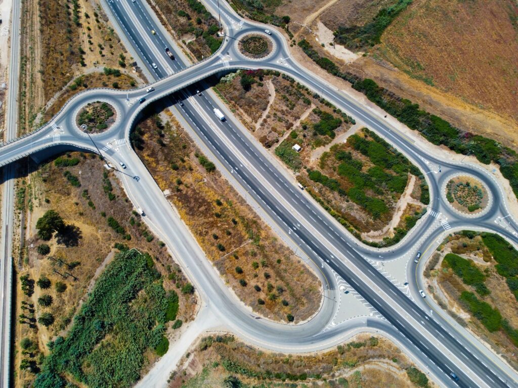 Aerial view of diverging roads representing rupiah outlook splits between competing market forces