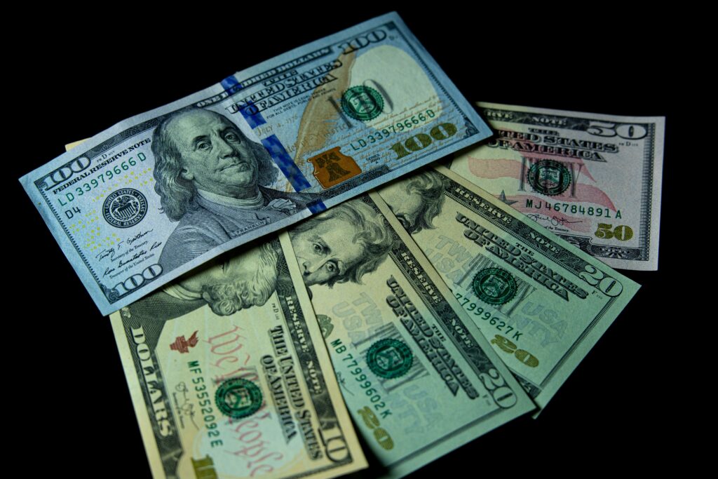 US dollar banknotes in dramatic lighting as rupiah under pressure amid Iran conflict drives safe haven demand