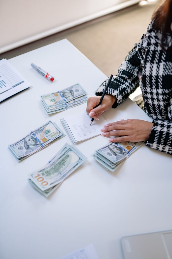 Person organizing US dollar cash and notes as USD accounts surge in Indonesia