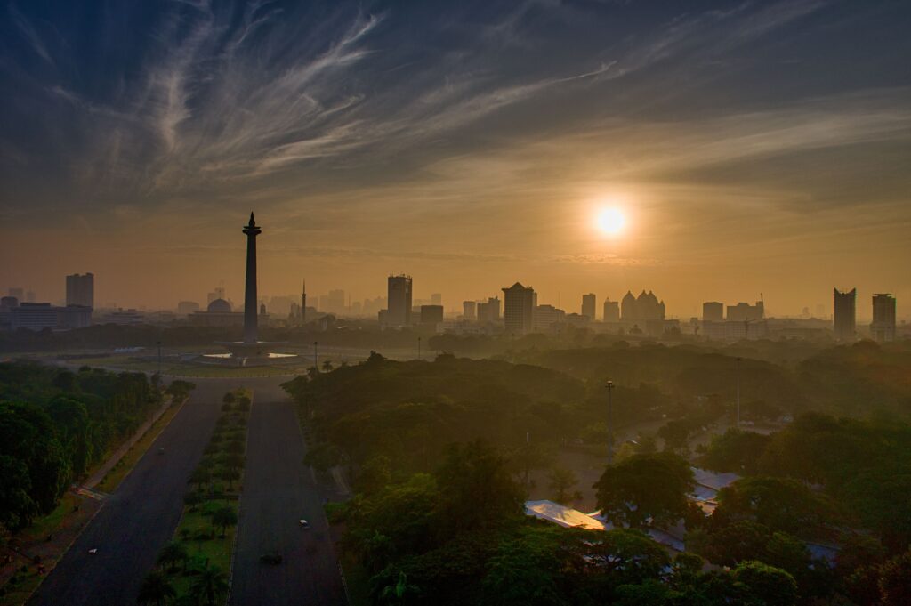 Indonesia Shock Transmission 2026 represented by Jakarta skyline, national economic resilience, policy coordination, and external market pressures