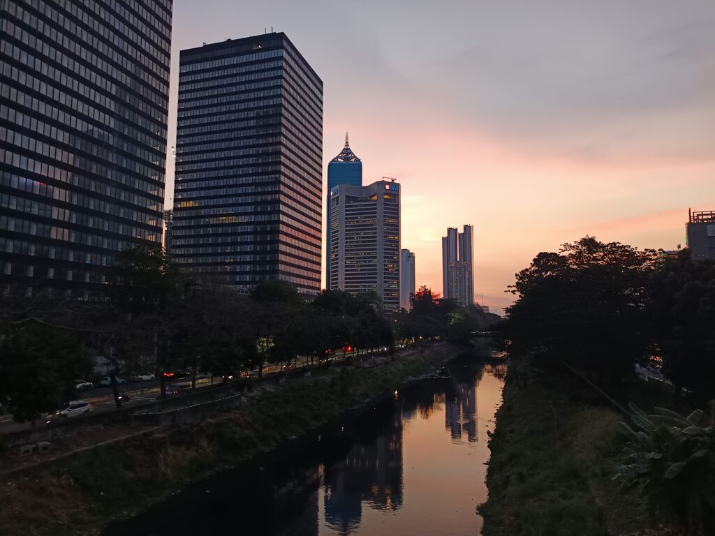 Rupiah Shock Absorption 2026 represented by Jakarta’s financial district, market uncertainty, and Indonesia’s economic resilience
