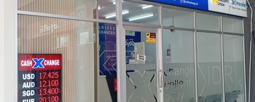 Cash X Change authorized money changer storefront in Ramayana, Kupang